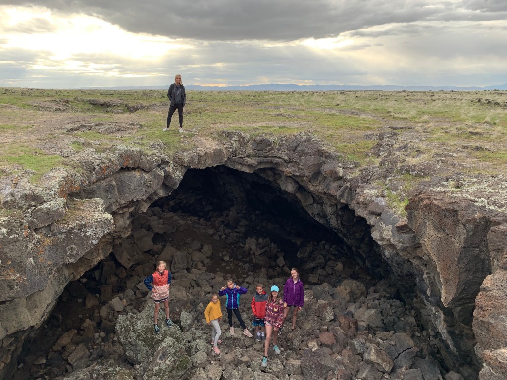 Kids exploring the lava tubes while Manina takes the easy route