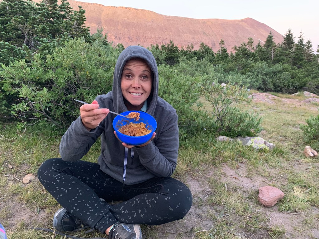 Manina enjoying Skurka beans and rice on way up to Kings Peak