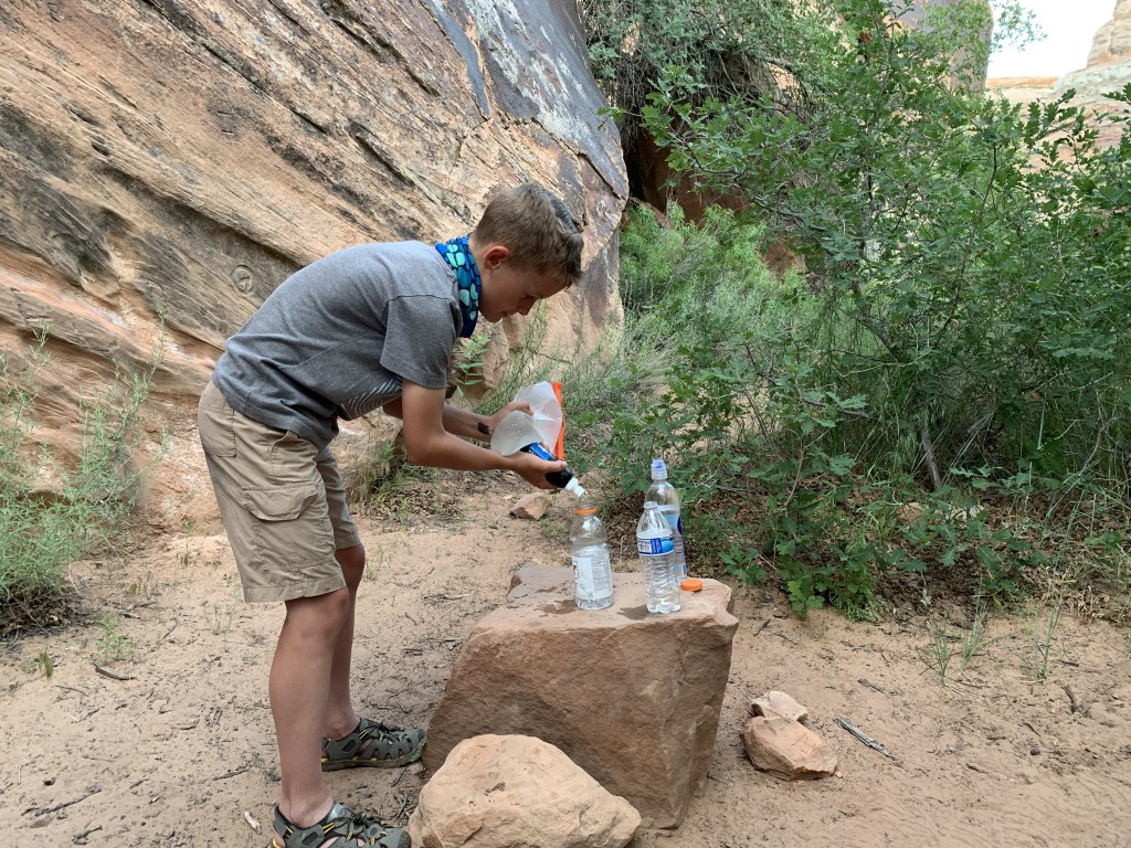 Drew filtering water from the Green River